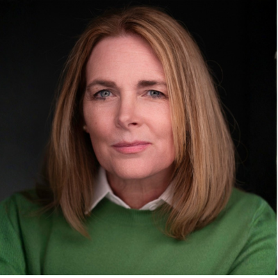 Woman with blonde hair in a green sweater