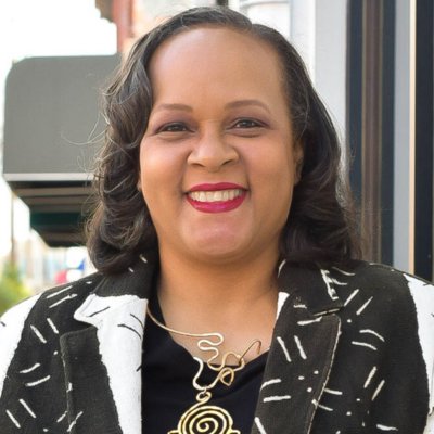 Portrait of Tanya Teat Foreman, woman standing in front of building